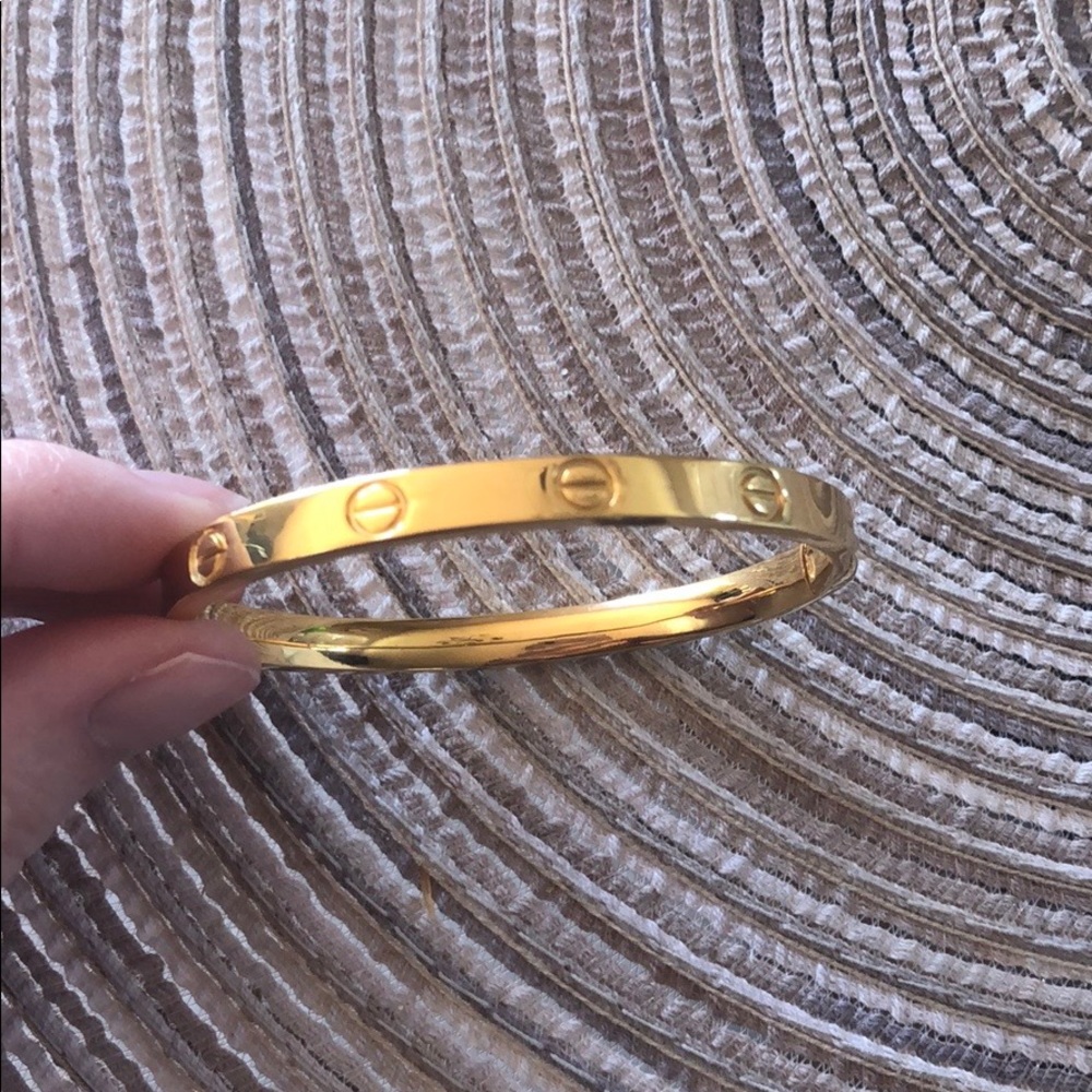 Gold bracelet resembles a love bracelet